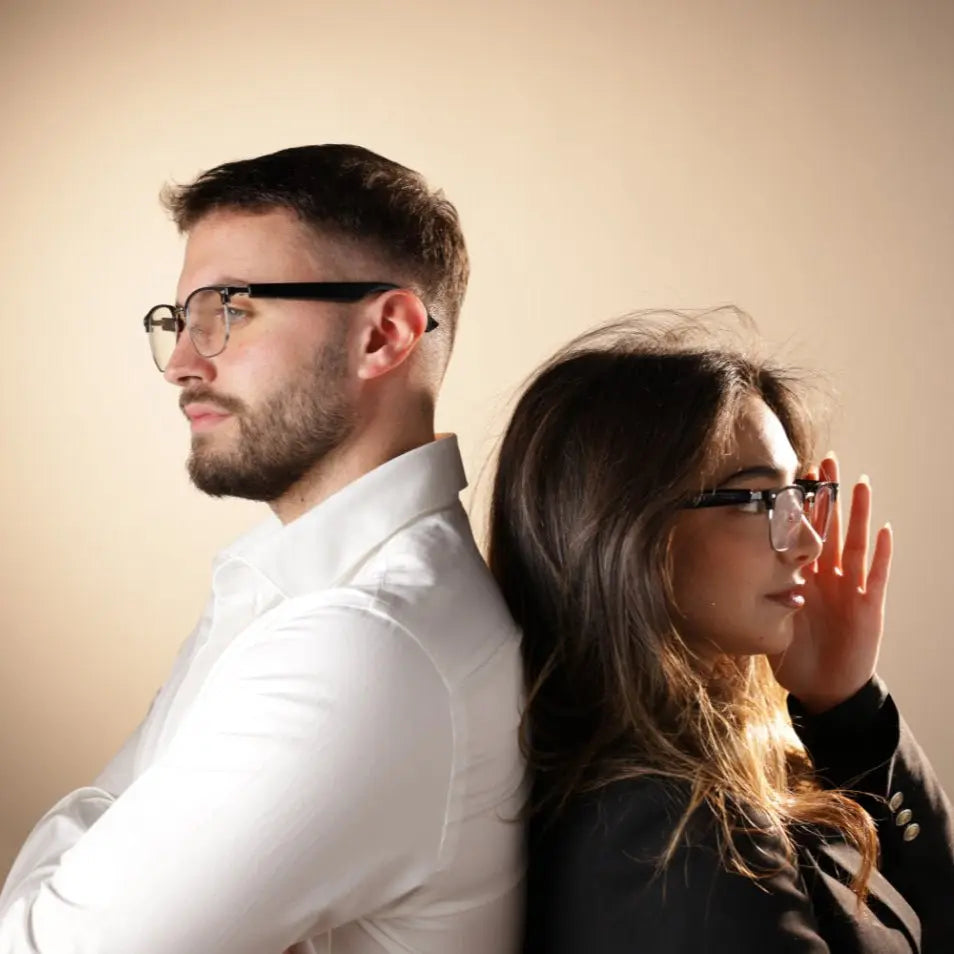 Professional man and woman modeling DUSK Halo smart blue light glasses designed for work and screen use
