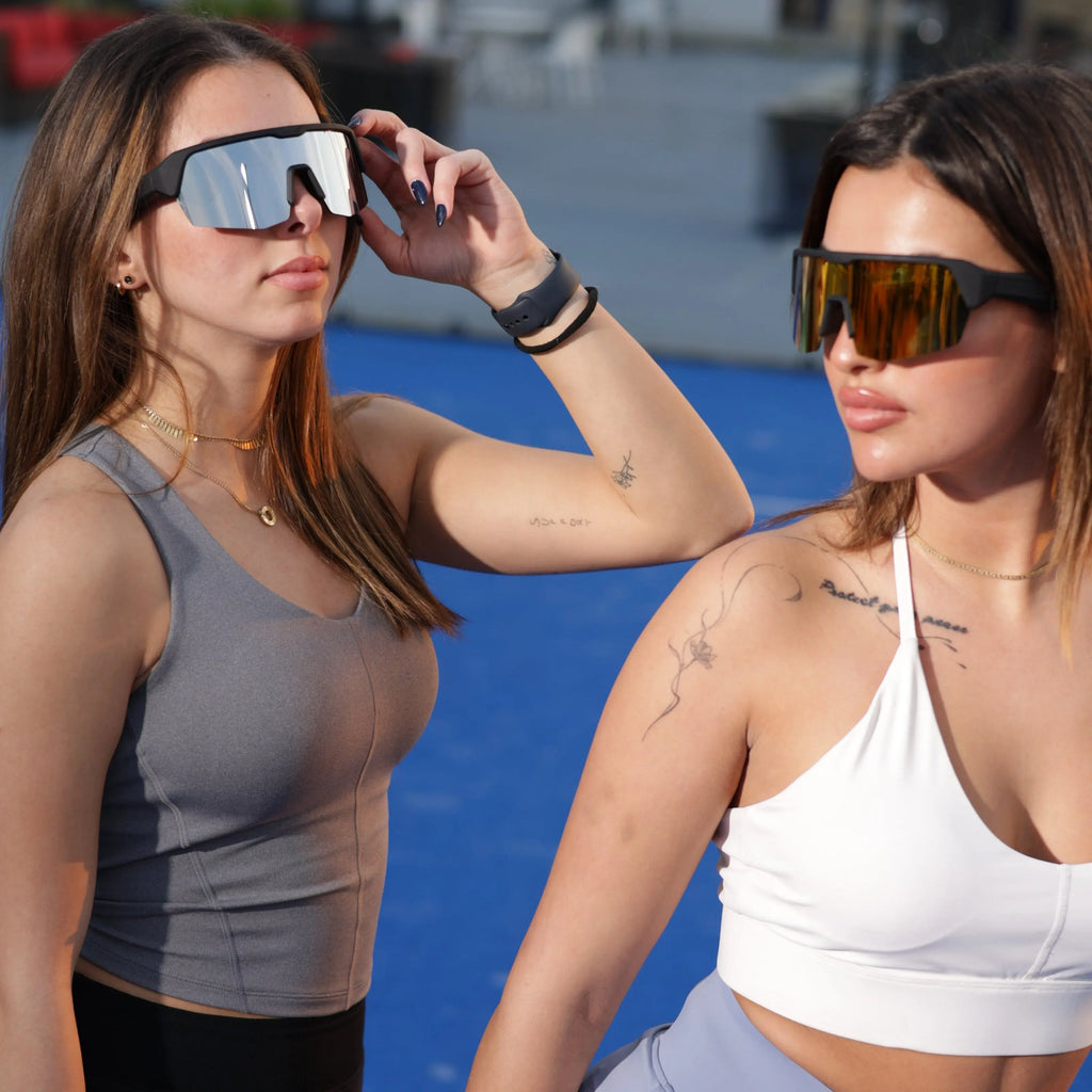 Two women wearing DUSK Apex smart sports glasses for fitness and running activities